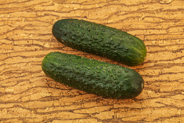 Green fresh cucumbers over background