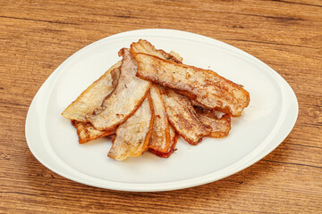 Roasted juicy bacon in the plate
