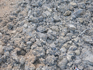 plowed and dug brown soil for background
