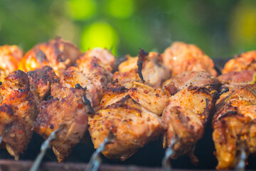 Close up view of roasted meat prepairing on barbeque.