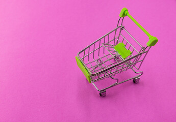 an empty shopping basket stands on a colored background