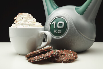 Heavy kettlebell with delicious chocolate cookies and large mug of coffee with whipped cream and...