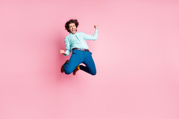 Photo portrait full body view of crazy guy celebrating shouting jumping up isolated on pastel pink...
