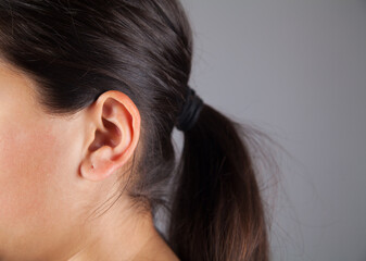 Fototapeta premium Closeup picture of young woman's ear.