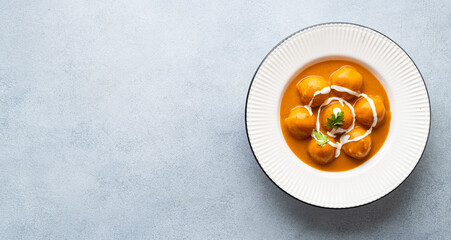 Malai Kofta Curry in a white plate, view from above, copy space