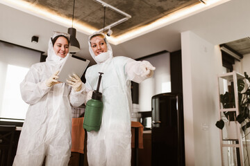 Specialists in protective suits take samples from surfaces in the home to test for a new corona...