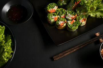 Vietnamese spring rolls with dipping sauce and vegetable on dinning table