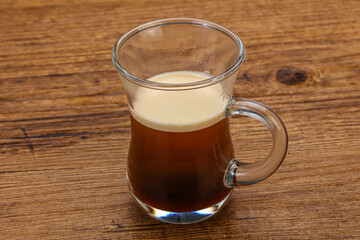 Hot Espresso coffee over wooden table