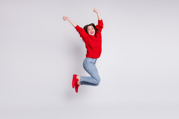 Full length body size photo of jumping high girl gesturing like winner wearing bright casual outfit isolated on grey pastel color background