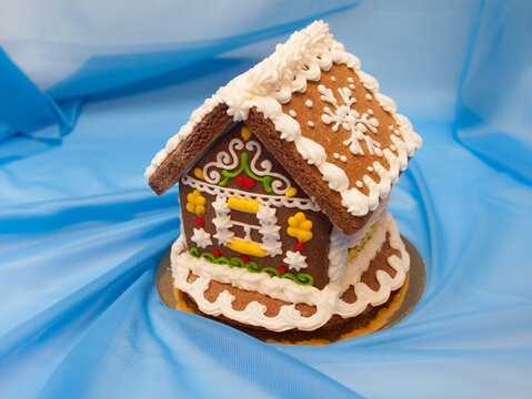 A house made of gingerbread on a blue background