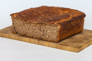 Rye homemade bread on wooden cutting Board on white background