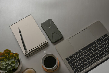 Workspace with laptop, stationery, coffee cup and copy space on white desk