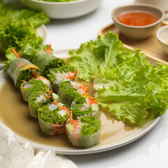 Asian appetiser, Vietnamese spring rolls served with dipping sauce on dinning table