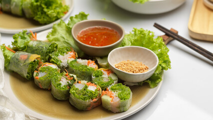 Asian appetiser, Vietnamese spring rolls served with dipping sauce on dinning table