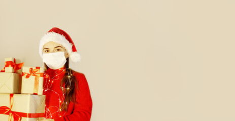 Fototapeta na wymiar woman in red sweater,medical mask,santa hat,with many christmas gift boxes after xmas shopping. female in mask holds holiday presents. Surprise gifts concept.banner