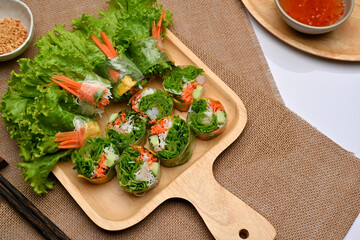 Vietnamese spring rolls on wooden tray serving with dipping sauce