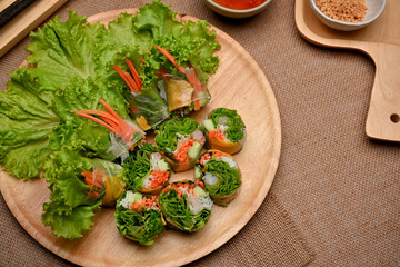 Vietnamese spring rolls served with dipping sauce on dinning table