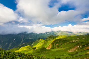 Obraz premium Beautiful mountain landscape at Caucasus mountains with clouds and blue sky