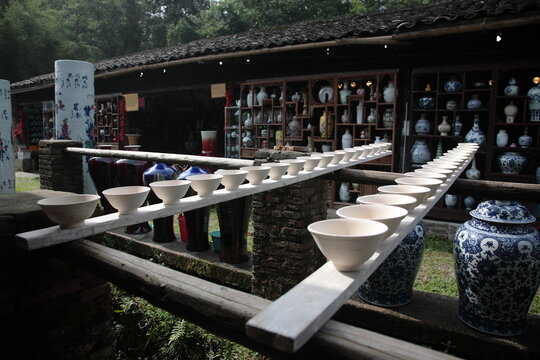 View of Drying Porcelain bowls clay body on row of wooden boards at Ancient ceramic Kiln in Jingdezhen, Jiangxi, China. 