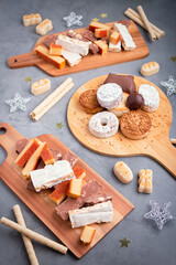 Traditional Spanish Christmas sweets turron, polvorones, mantecados with Christmas decor on grey table top