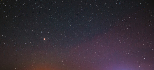 Night Starry Sky With Glowing Stars. Bright Glow Of Planet Venus In Sky Among Stars. Sky In Lights Of Sunset Dawn