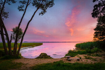 Fototapeta na wymiar Beautiful colorful sunset over the lake summer landscape.