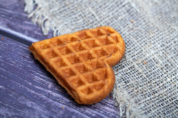 Delicious homemade cookies on the background of rough homespun fabric. Close-up, selective focus.