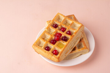 waffles with honey and berries for breakfast close-up.