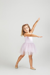 Charming little child girl dreams of becoming a ballerina. ballet dancer in pink tutu