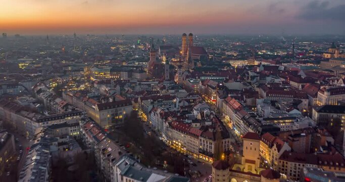 Beautiful Munich, Germany Establishing Shot Hyper Lapse above City Center with Frauenkirche Cathedral and Marienplatz, Day to Night Time Lapse with Sunset and Big City traffic