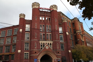 Moscow Electric Lamp Plant. Construction of industrial, industrial building. Ancient house facade....