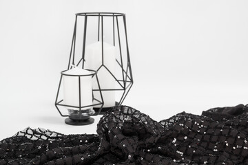 Obraz premium Beautiful sequin embroidery on fabric tulle mesh. Abstract ornamental curls. Textile industry black white background