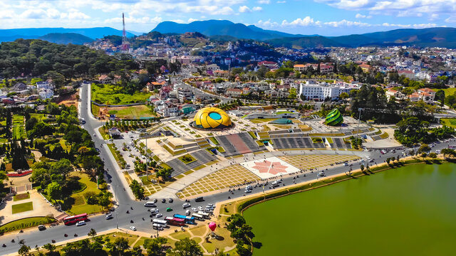 Aerial view of a Da Lat City with development buildings, transportation. Tourist city in developed Vietnam. Center Square of Da Lat city with Xuan Huong lake.