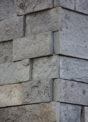 Vertical wall of bricks in cold tones