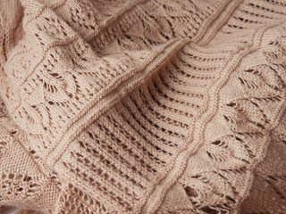 Knitted background. Knitted texture. A sample of knitting from wool. Knitting Pattern.