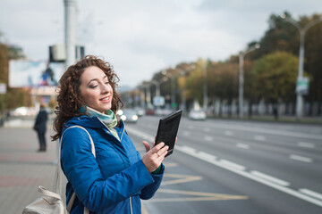 Fototapeta premium Girl student in a blue jacket on the street