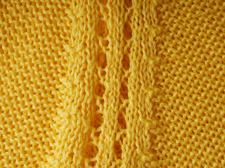 Knitted background. Knitted texture. A sample of knitting from wool. Knitting Pattern.