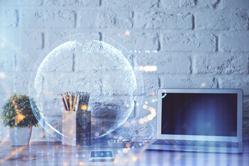 Double exposure of desktop with computer and world map hologram. International data network concept.
