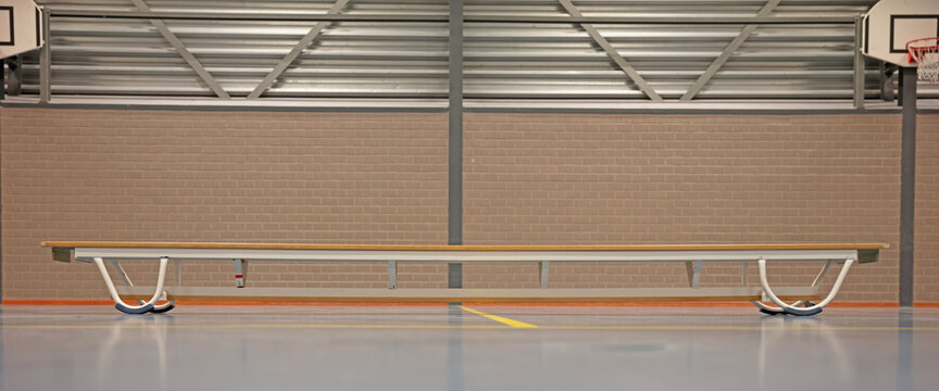 Empty wooden benche in school gym