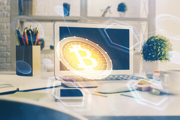 Multi exposure of blockchain and crypto economy theme hologram and table with computer background....