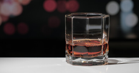 Simple glass of luxury whisky against dark background.