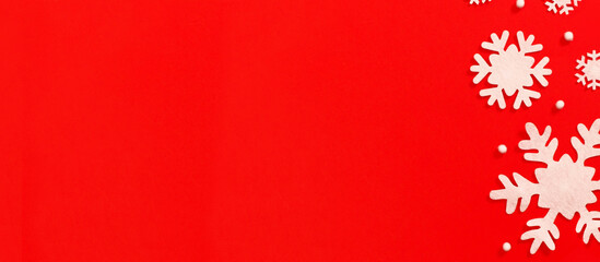 Christmas frame made of snowflakes on red background with copy space. Christmas concept. Flat lay, top view	