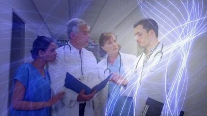 Digital animation of glowing purple light trails against team of medical professionals discussing to - Powered by Adobe