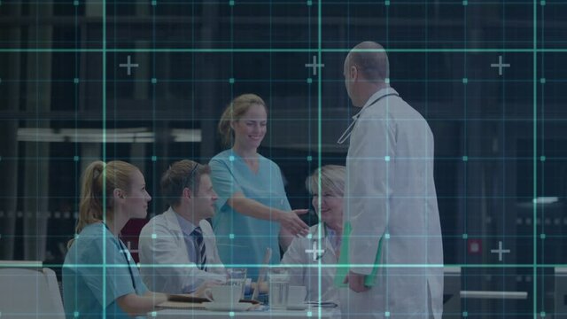 Digital animation of grid network against male doctor shaking hands with team of medical professiona