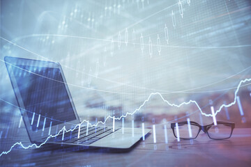 Forex Chart hologram on table with computer background. Multi exposure. Concept of financial markets.