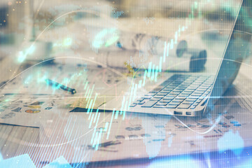 Forex market chart hologram and personal computer background. Multi exposure. Concept of investment.