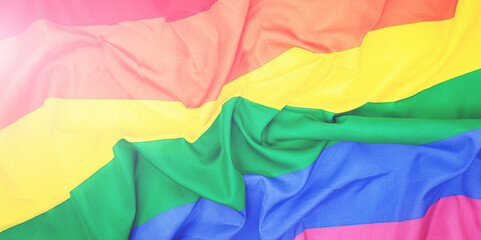LGBTQ pride creased rainbow flag slightly faded. top view banner or backdrop LGBT background