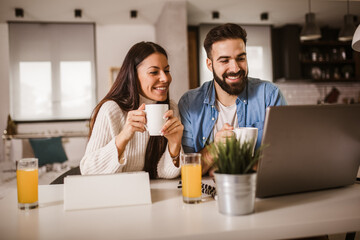 Happy couple enjoying work from home.