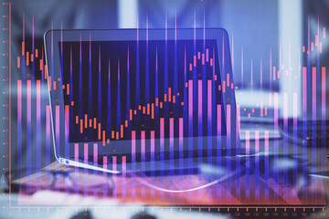 Forex market chart hologram and personal computer background. Double exposure. Concept of investment.