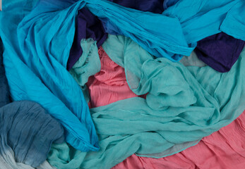 Large pile of tangled colored scarves